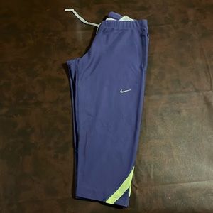 Like new Nike running capri. Women’s size small. Purple and yellow.